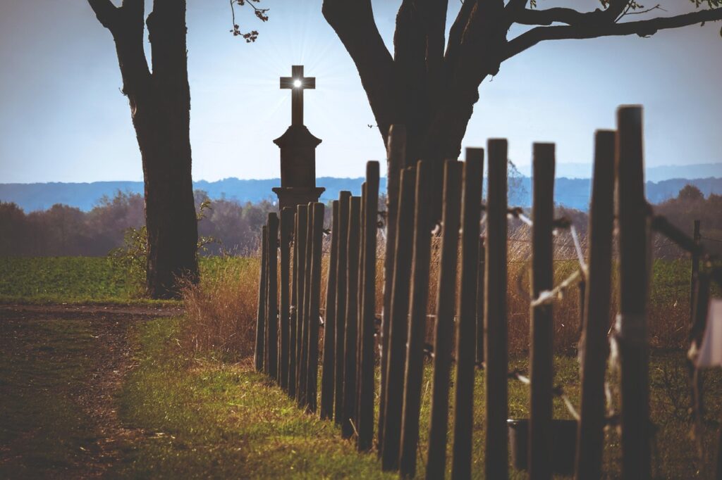Wayside cross with Jesus figure on a path
